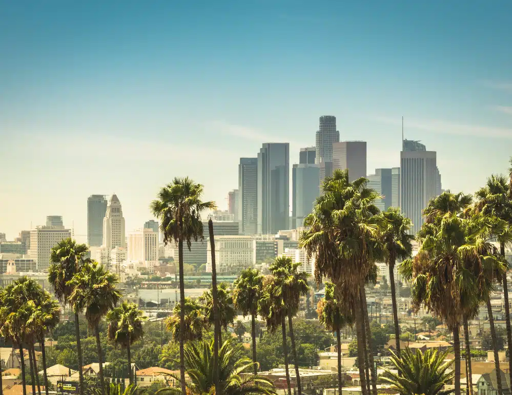 the Los Angeles city skyline with a bright blue sky